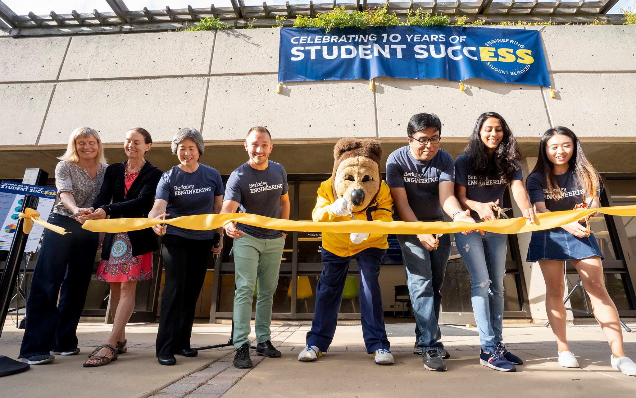 Photo of Niraj with a few of his colleagues cutting a ribbon for the Berkeley Engineering Student Services 10th year anniversary.